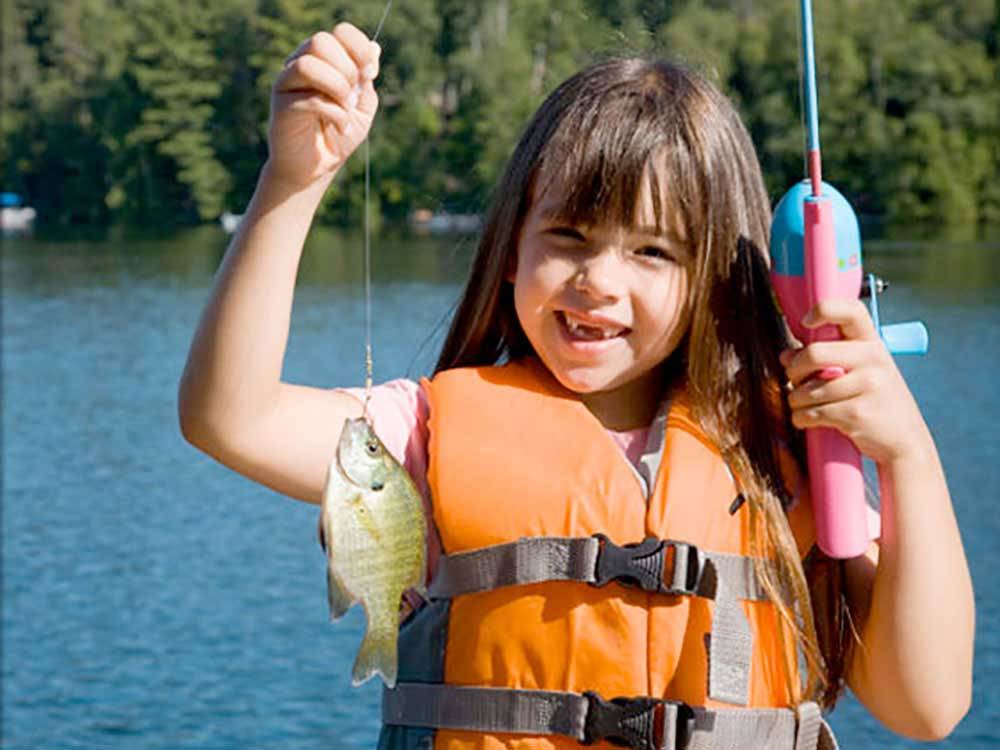 A little girl holding a fish she has caught at ALLATOONA LANDING MARINE RESORT