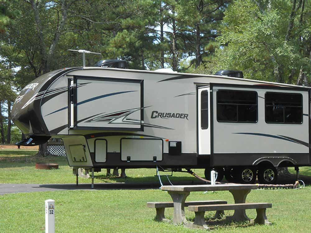 A fifth-wheel trailer with a picnic table at ALLATOONA LANDING MARINE RESORT