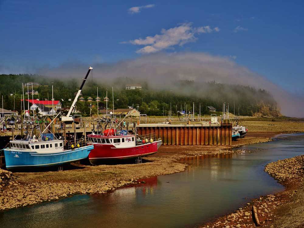 Boats at low tide at Bay of Fundy nearby at PONDEROSA PINES CAMPGROUND