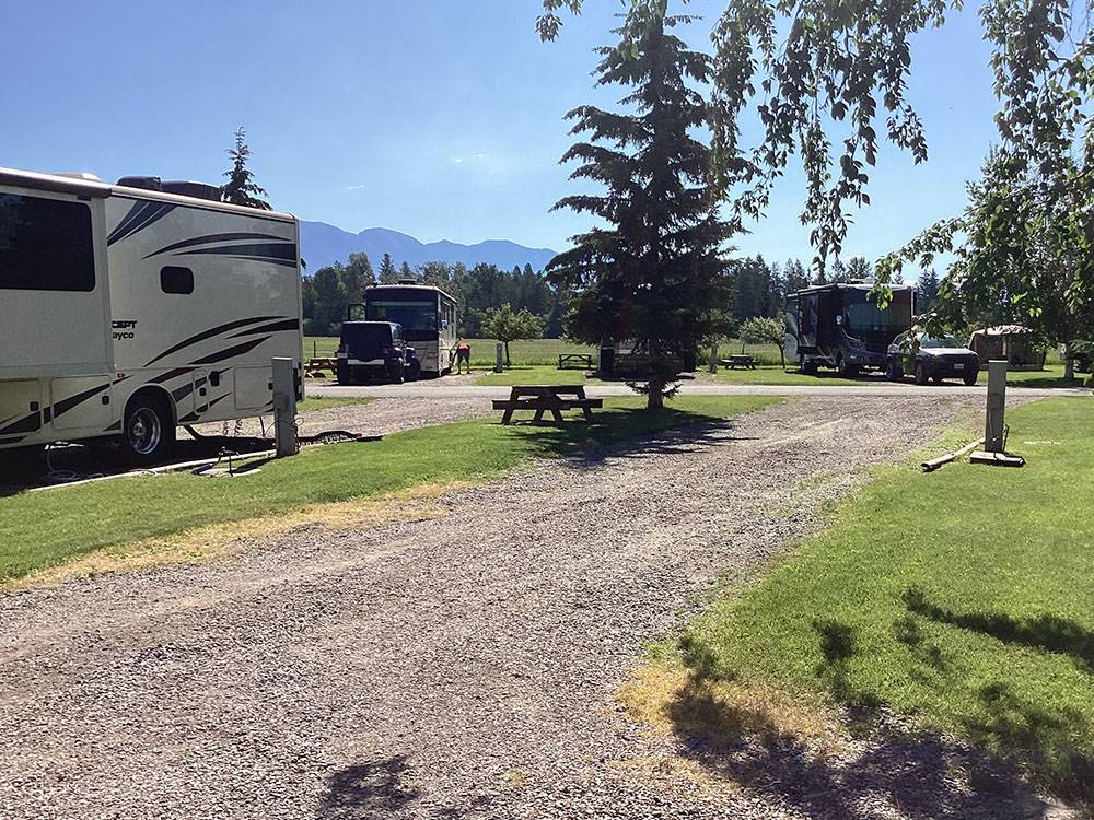 An empty gravel RV site at ROCKY MOUNTAIN 'HI' RV PARK AND CAMPGROUND