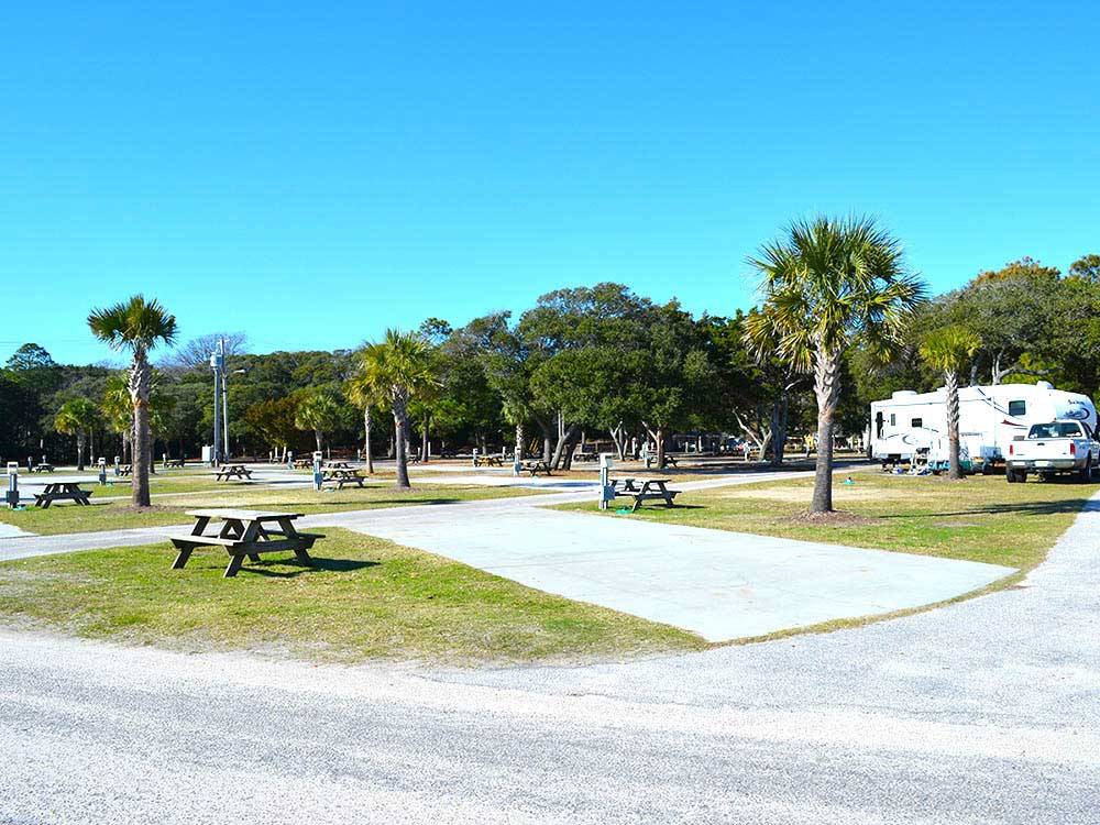 Picnic tables next to an empty site at OCEAN LAKES FAMILY CAMPGROUND