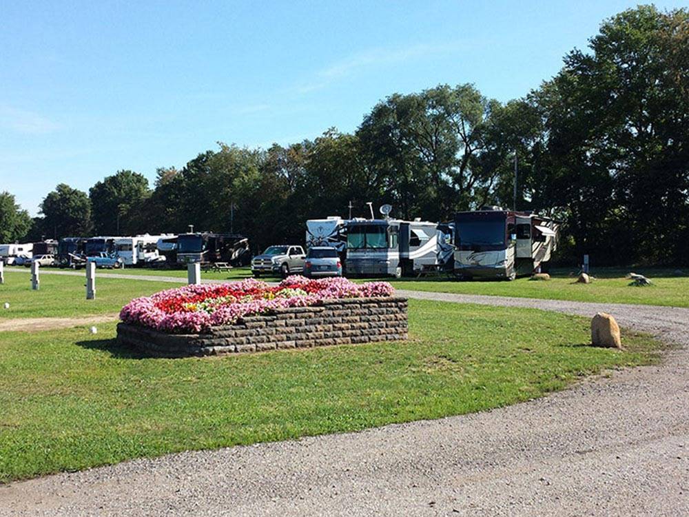 Winding road and flower bed near RVs at ELKHART CAMPGROUND