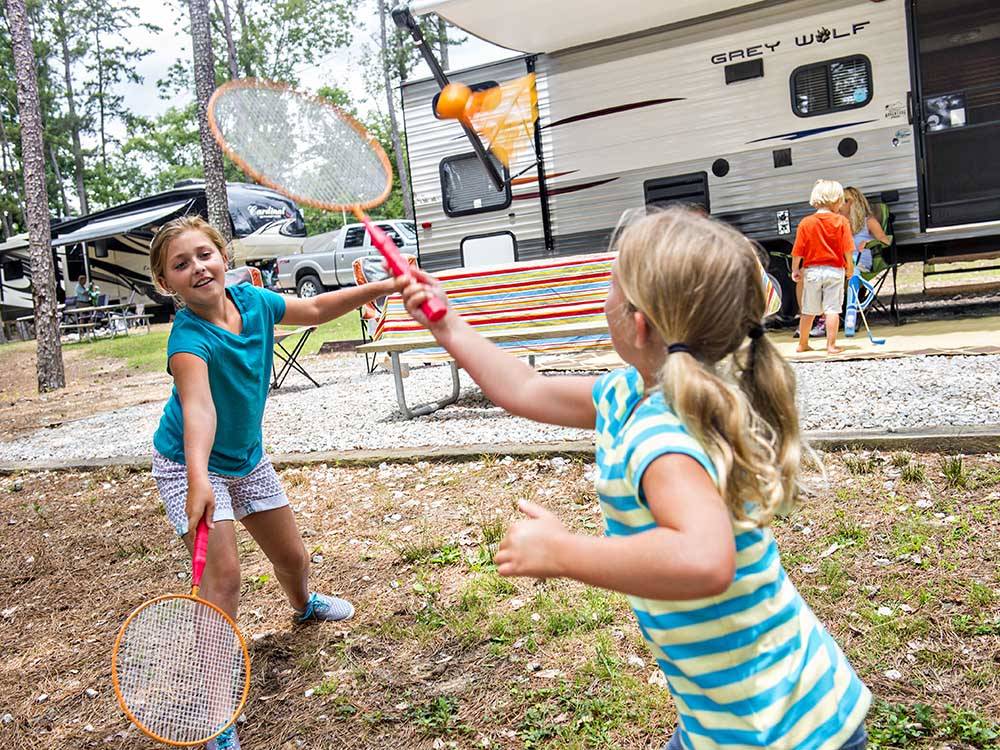 Two girls playing badminton at STONE MOUNTAIN PARK CAMPGROUND