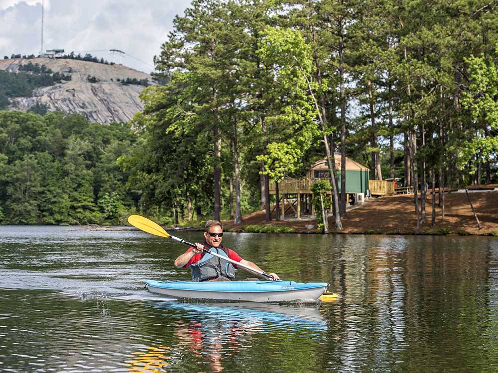 A man kayaking on the water at STONE MOUNTAIN PARK CAMPGROUND