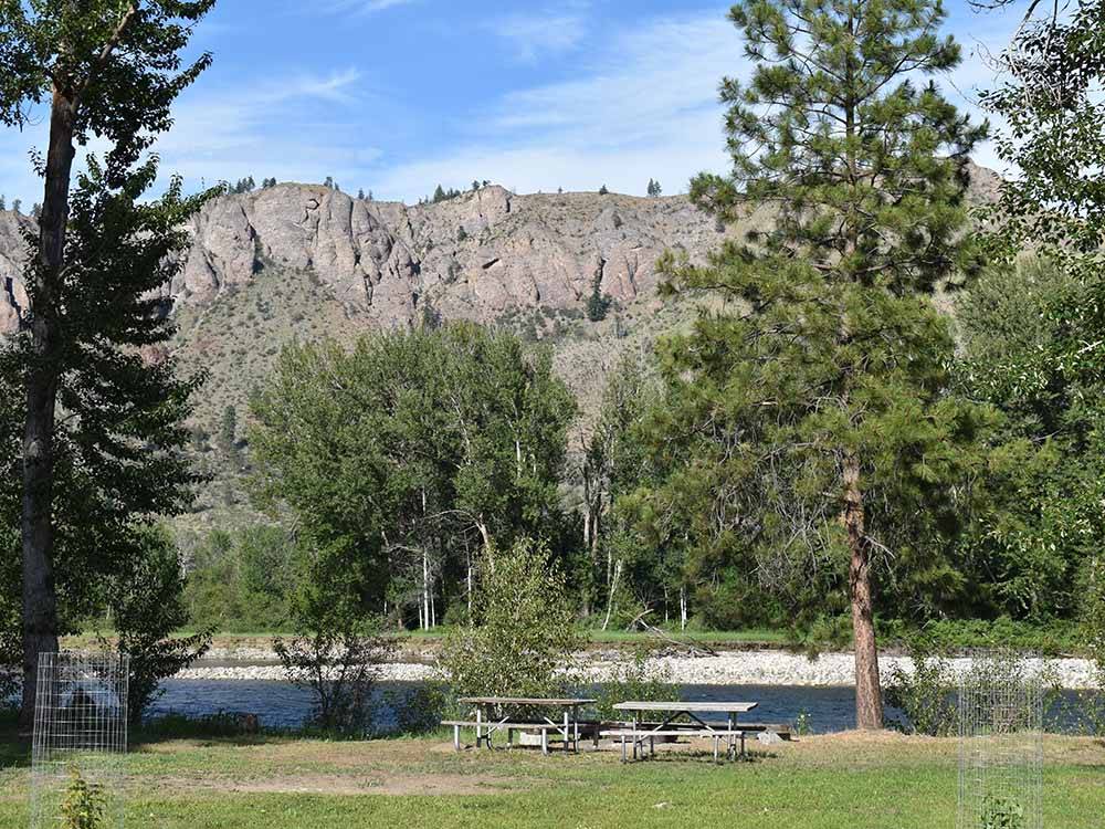 Picnic benches by the river at RIVERBEND RV PARK OF TWISP