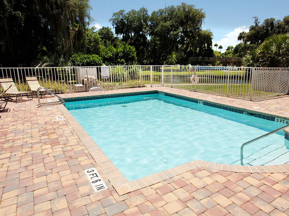 Swimming pool at campground with fence around at ENCORE BULOW RV