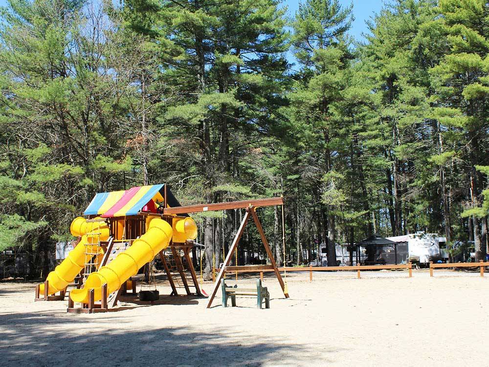 Playground with swing set at PINE ACRES RESORT