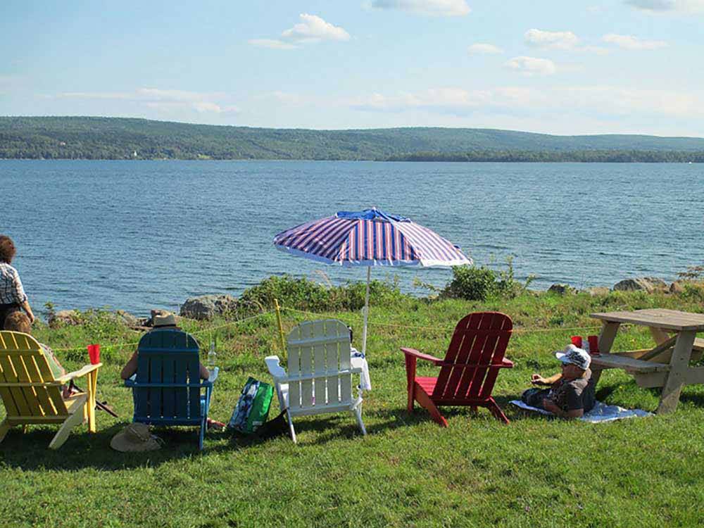 Sitting lakeside in Adirondack chairs at BRAS D'OR LAKES CAMPGROUND ON THE CABOT TRAIL