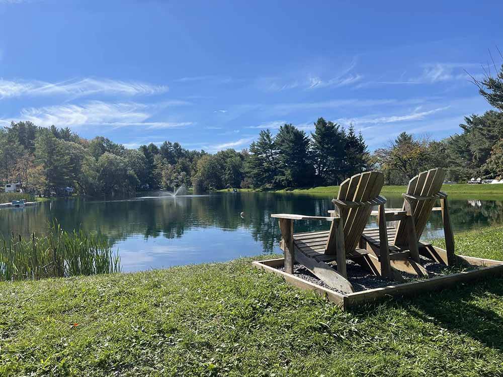 Chairs overlooking the pond at COOPERSTOWN SHADOW BROOK CAMPGROUND