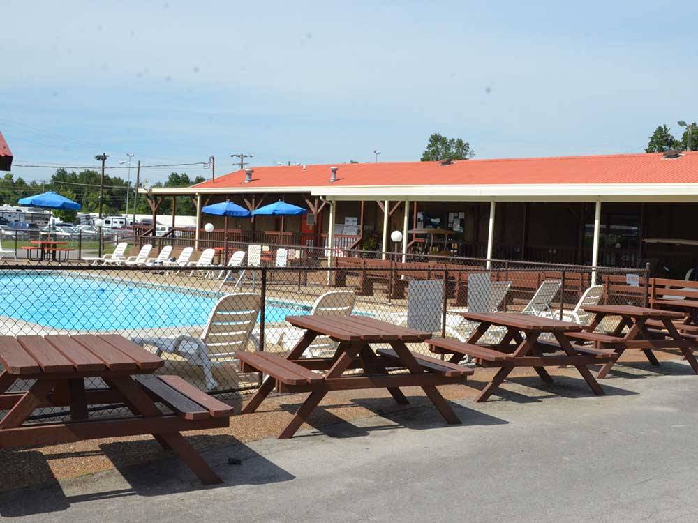 View of swimming pool and picnic tables at TWO RIVERS CAMPGROUND