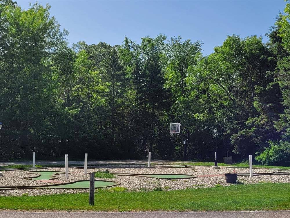 Miniature golf course by the basketball court at BARABOO RV RESORT BY RJOURNEY