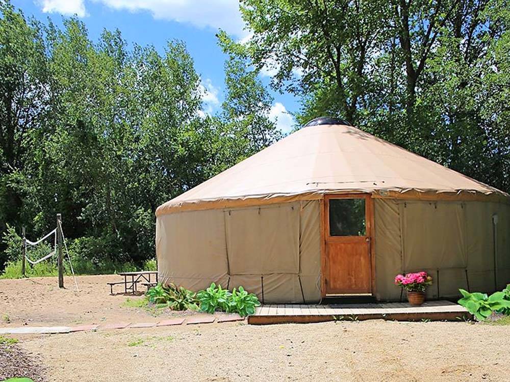 One of the yurts with a volleyball net at BARABOO RV RESORT BY RJOURNEY
