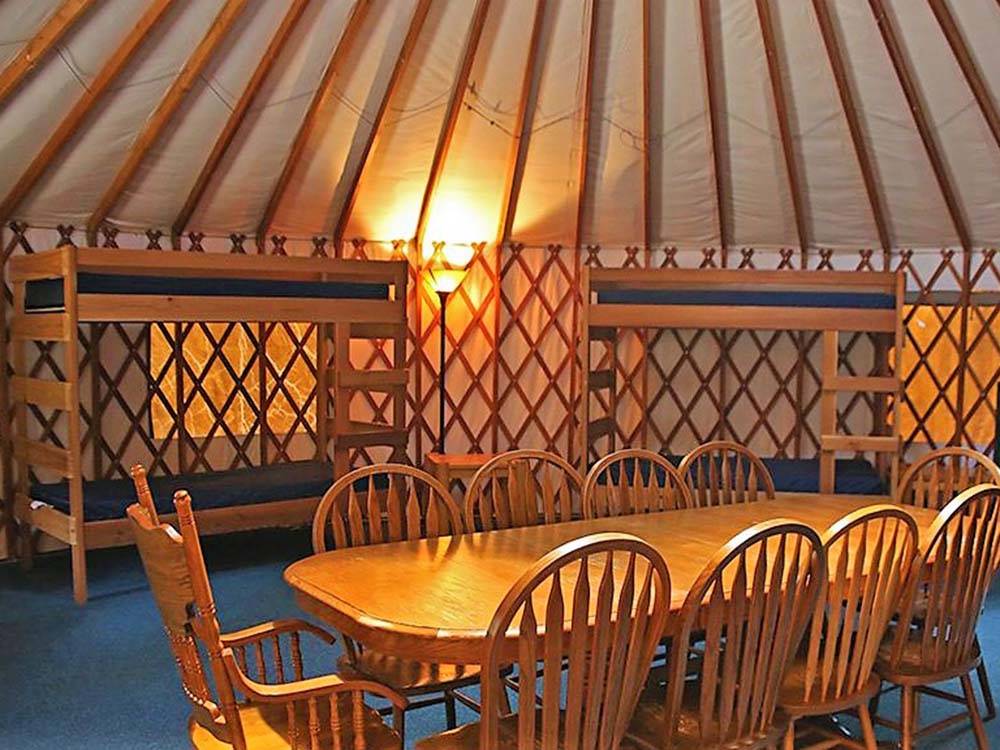 The beds and table inside the yurt at BARABOO RV RESORT BY RJOURNEY