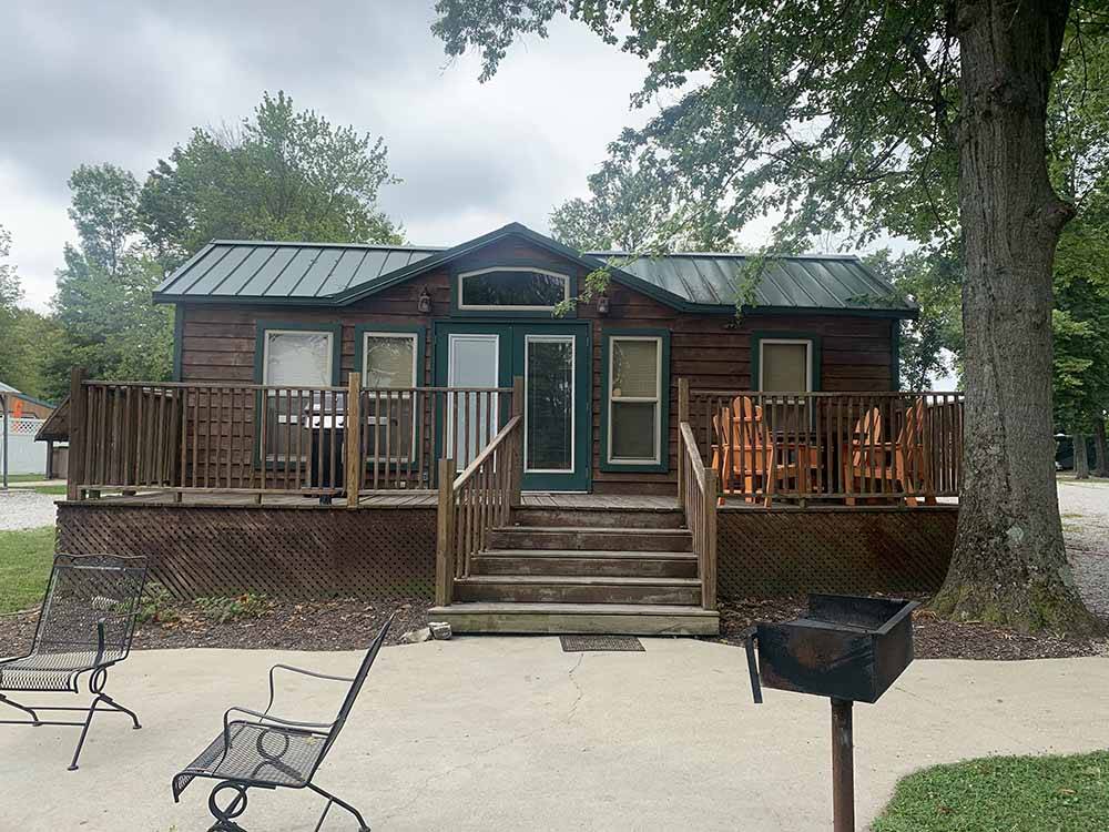 One of the cabin rentals with a deck at TERRE HAUTE CAMPGROUND