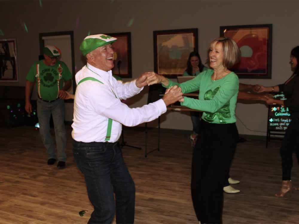 A couple on St. Patrick's Day dancing at FAYETTEVILLE RV RESORT & COTTAGES