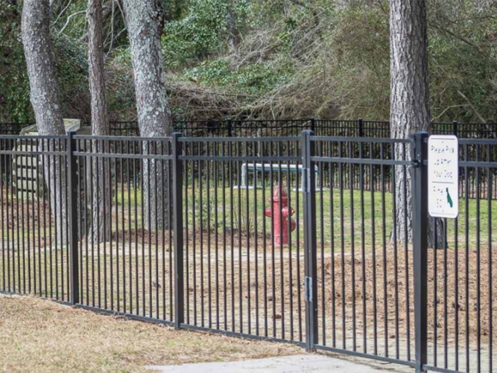 The fenced in pet area at FAYETTEVILLE RV RESORT & COTTAGES