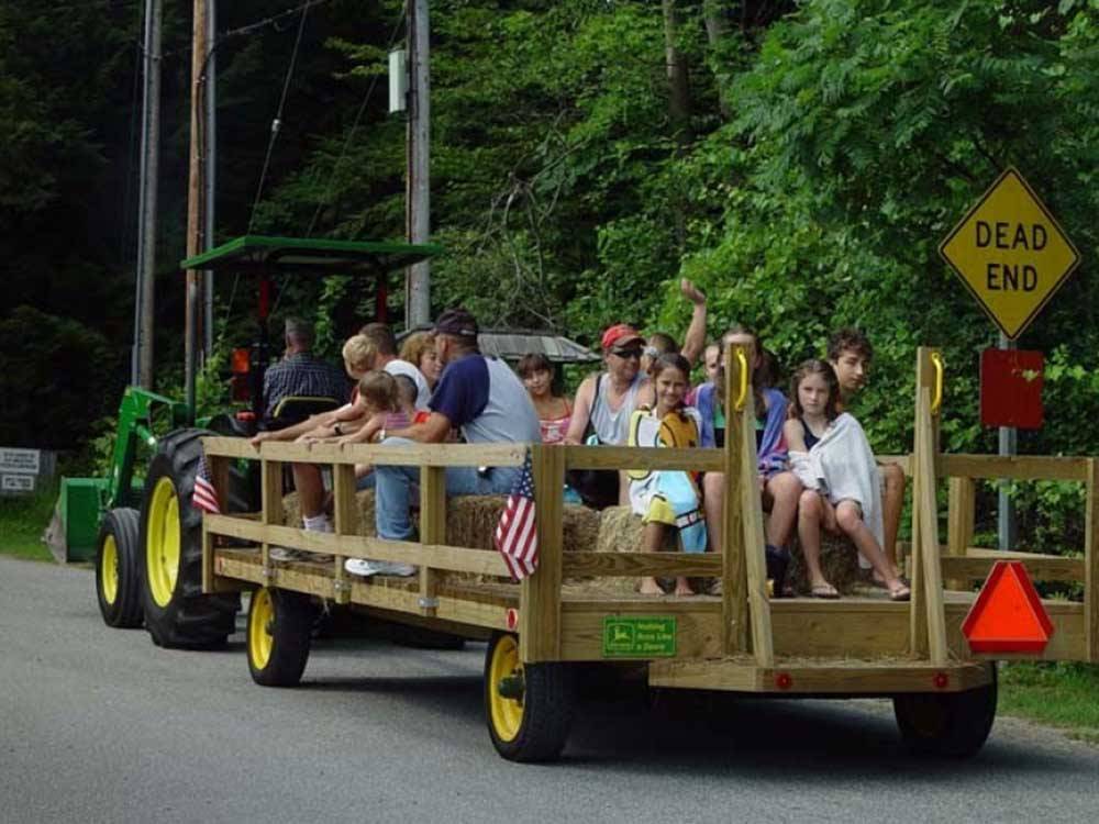 People riding on a tractor at LAKE GEORGE CAMPING VILLAGE