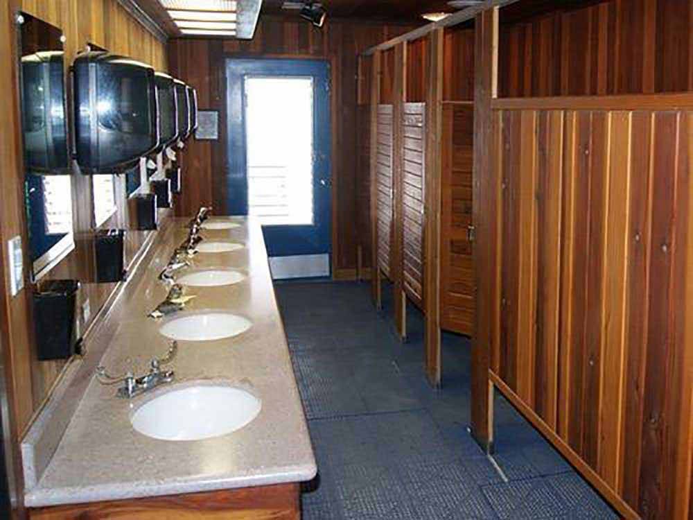 A clean wood paneled bathroom at HITCHIN' POST RV PARK