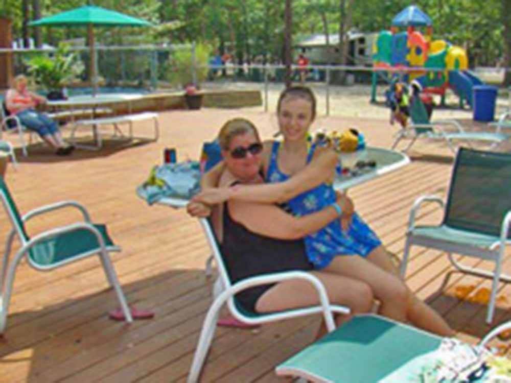 Mother and daughter hanging out pool side at ATLANTIC SHORE PINES CAMPGROUND