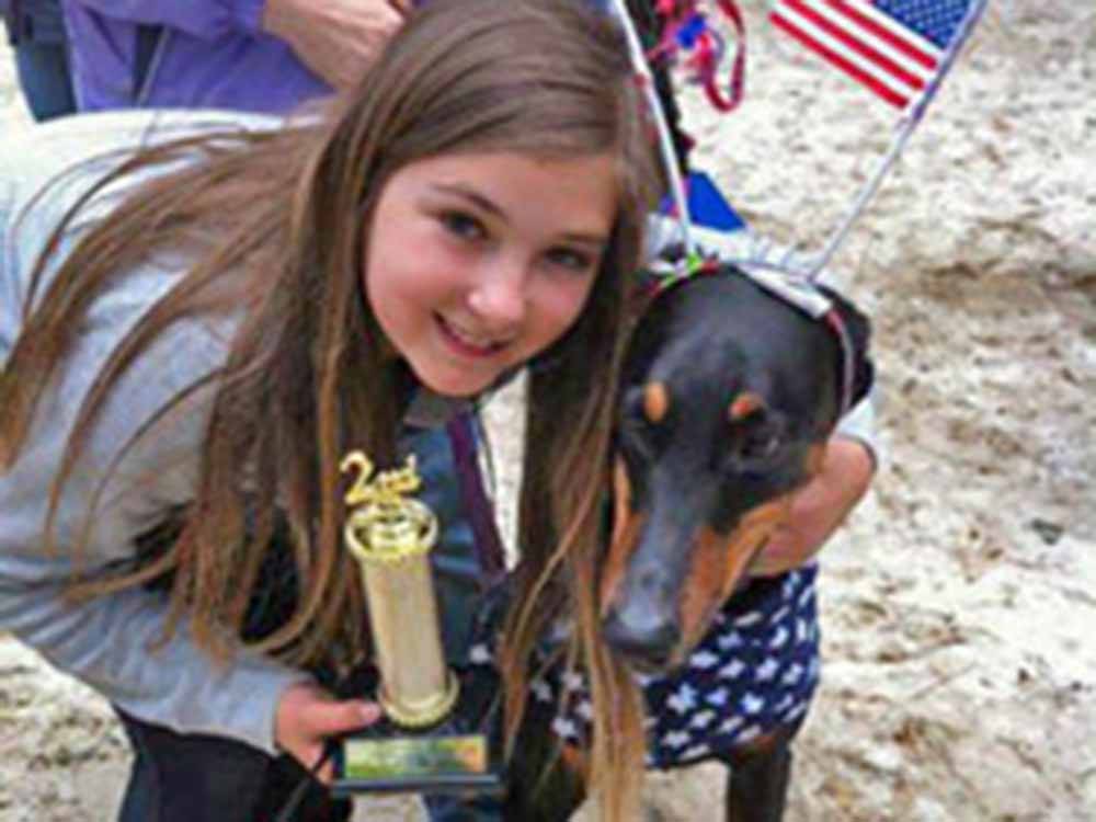 Girl proud of her second-place dog at ATLANTIC SHORE PINES CAMPGROUND