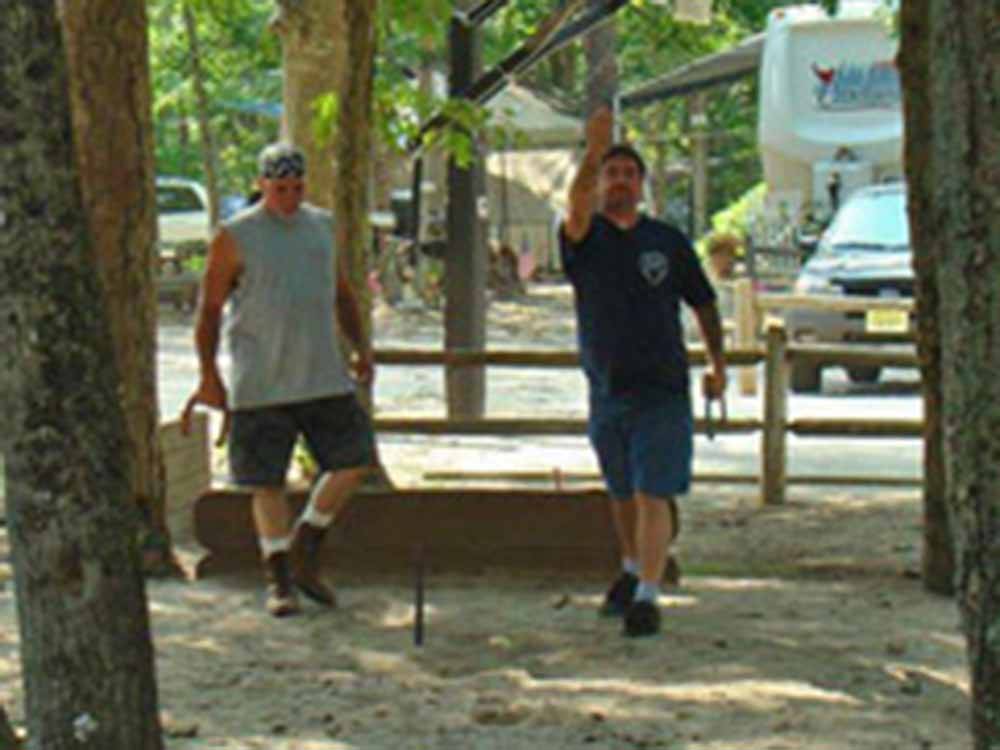 Two men playing horseshoes at ATLANTIC SHORE PINES CAMPGROUND