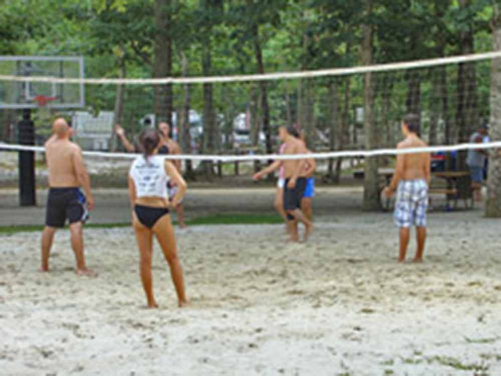 People playing beach volleyball at ATLANTIC SHORE PINES CAMPGROUND