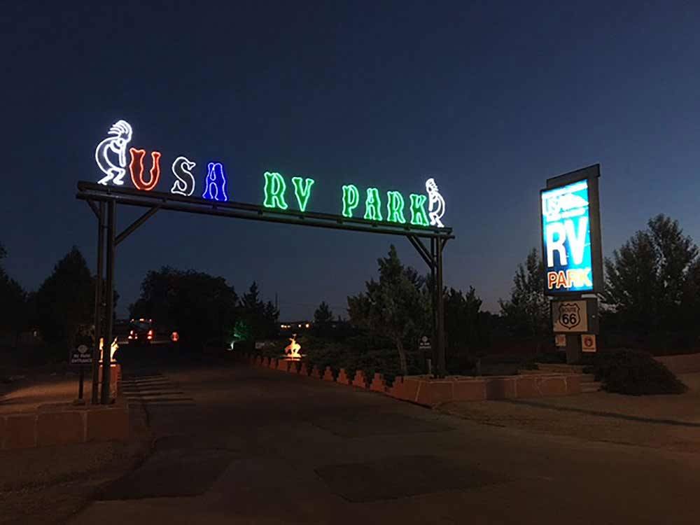 Park name in neon lights at entrance to RV park at USA RV PARK