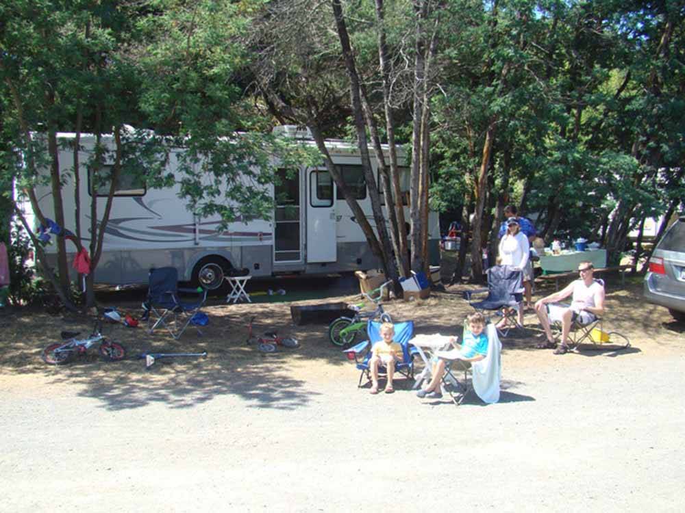 A family sitting around a campsite at CASINI RANCH FAMILY CAMPGROUND