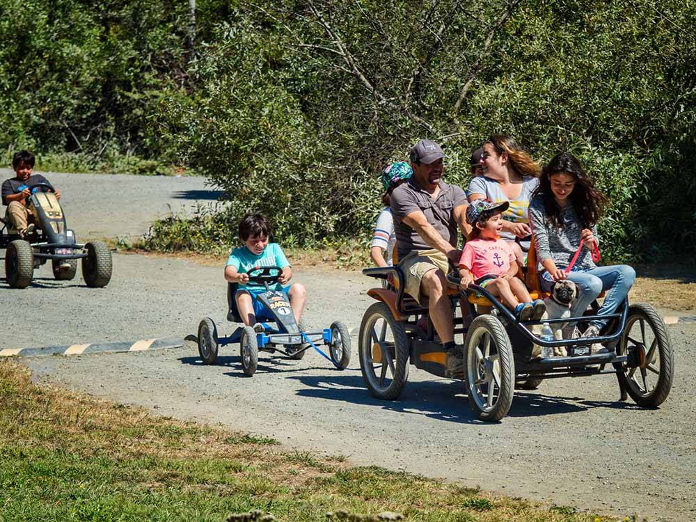 A family riding on peddle carts at CASINI RANCH FAMILY CAMPGROUND