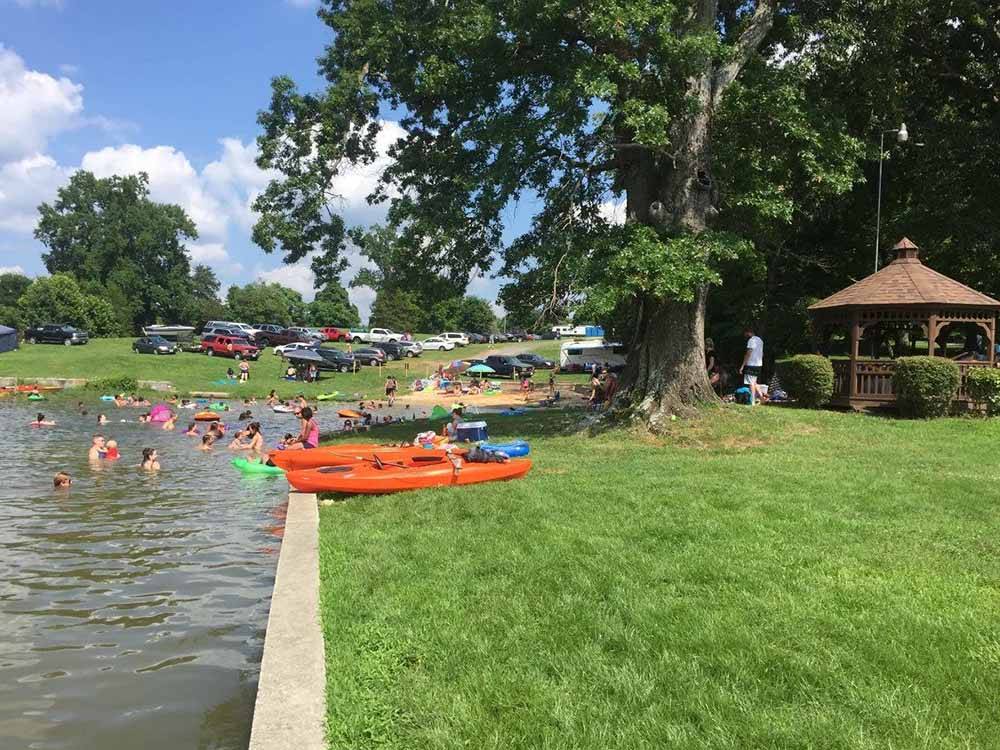 Cars parked and people in the water at CHRISTOPHER RUN CAMPGROUND