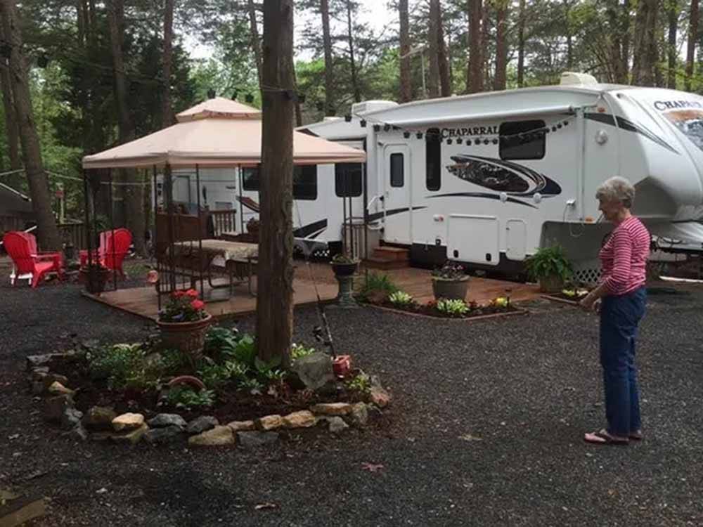 A person admiring her well-manicured campsite at CHRISTOPHER RUN CAMPGROUND