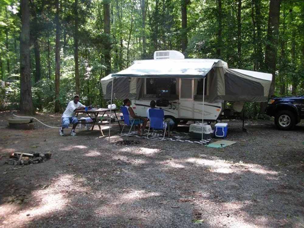 People hanging out near their pop-up camper at CHRISTOPHER RUN CAMPGROUND