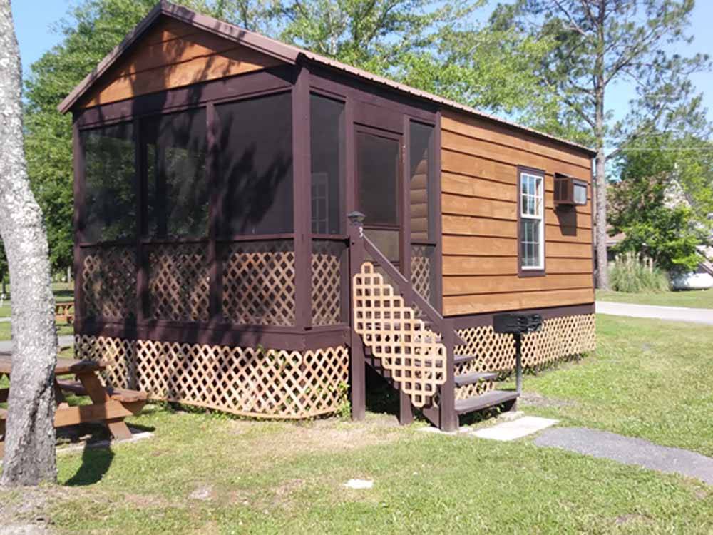 A rental cabin with an enclosed porch at LAKE CITY CAMPGROUND