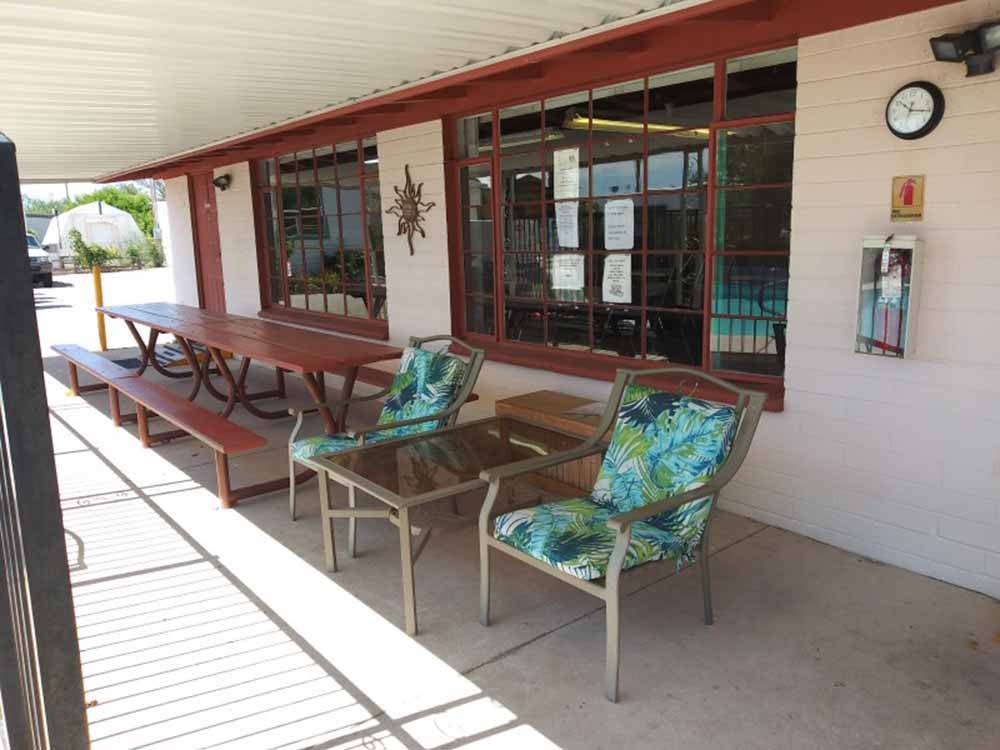 Chairs and picnic tables under the front office awning at SAN PEDRO RESORT COMMUNITY