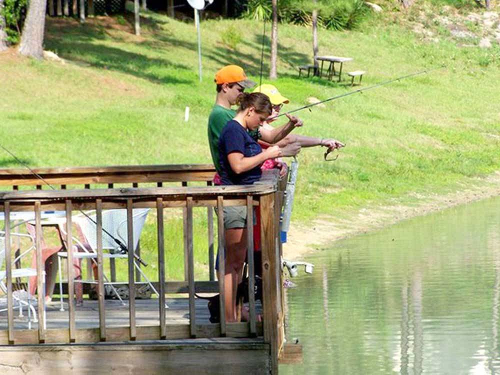 People fishing off the dock at TALLAHASSEE EAST CAMPGROUND