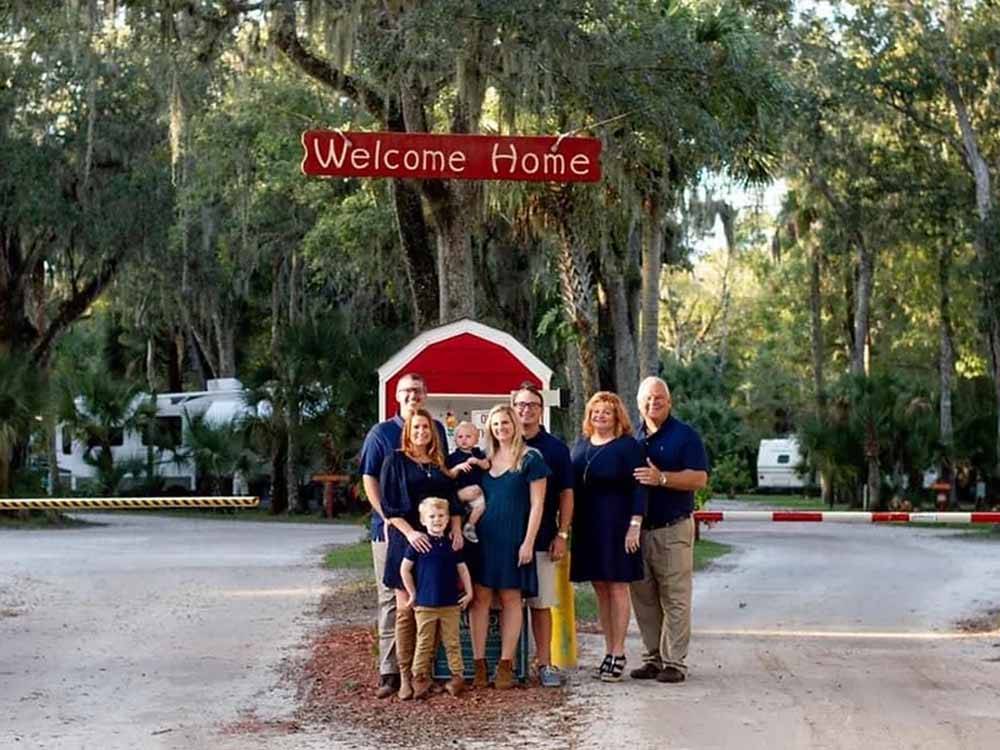 Group of people under welcome sign at SUGAR MILL RUINS TRAVEL PARK
