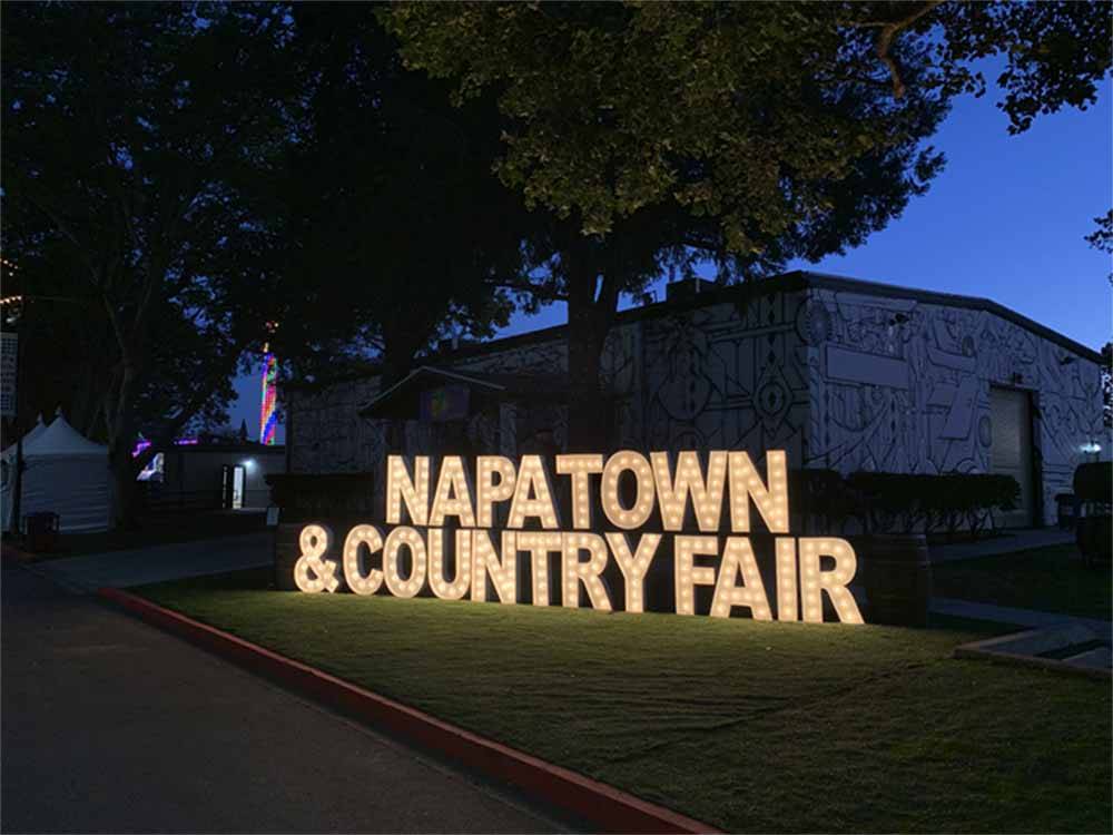 The lit up front entrance sign at NAPA VALLEY EXPO RV PARK