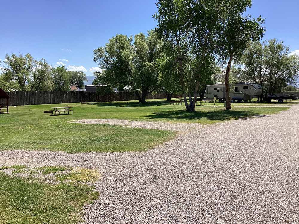 A row of back in gravel RV sites at BEAVERHEAD RIVER RV PARK & CAMPGROUND