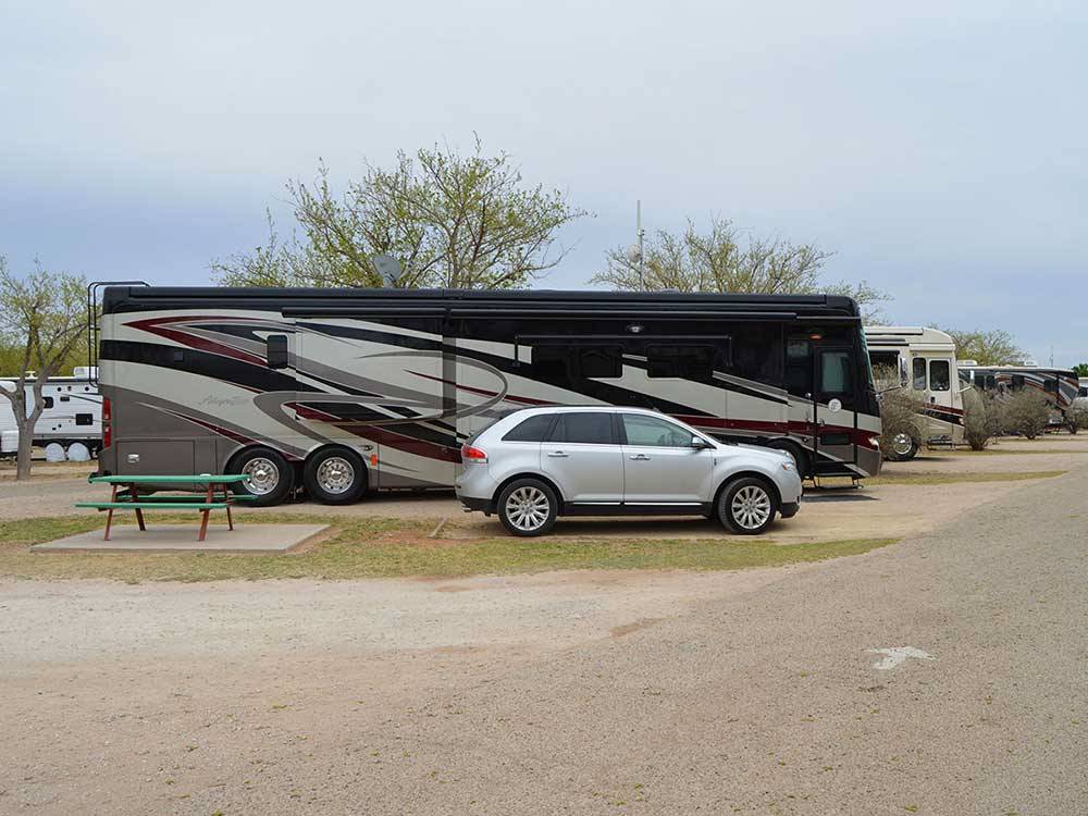 Motorhome in campsite with picnic table at MIDLAND/ODESSA RV PARK