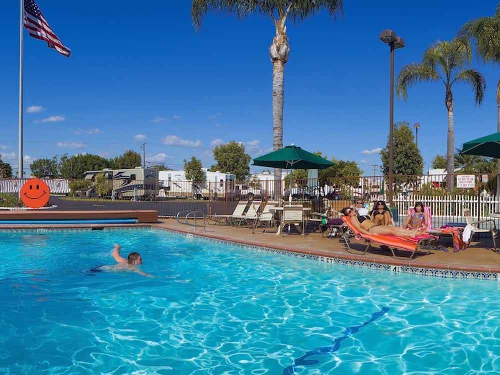 A person swimming in the pool at ORANGELAND RV PARK