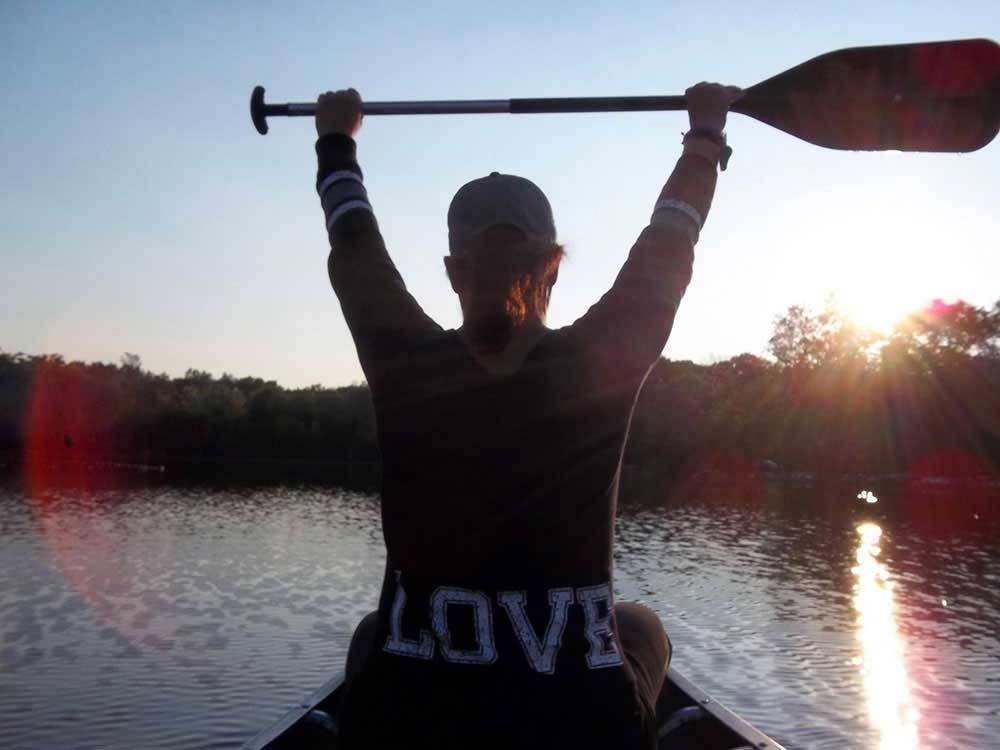 A woman with a shirt on that says LOVE kayaking at OTTER LAKE CAMP RESORT