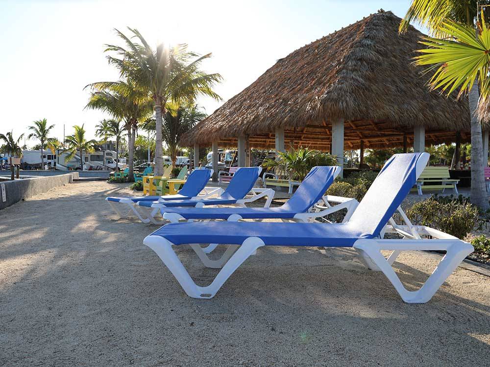 Lounge chairs under the shade at JOLLY ROGER RV RESORT