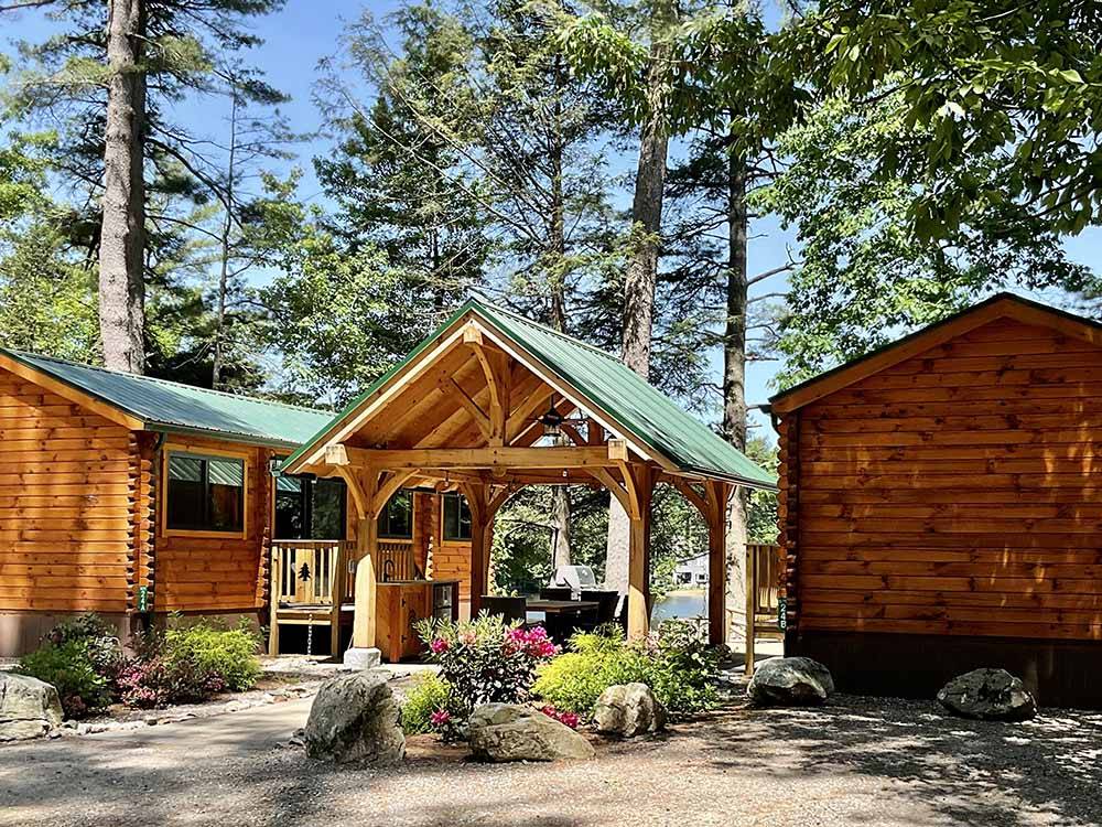A row of rustic rental log cabins at PINE ACRES FAMILY CAMPING RESORT