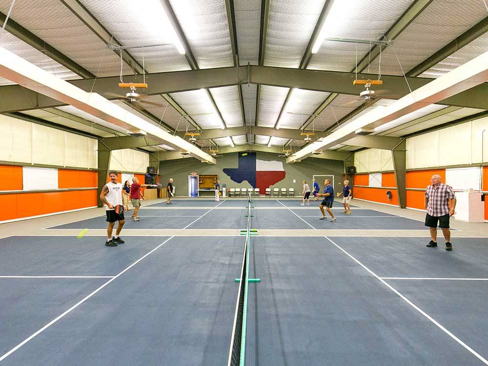 People playing at indoor tennis courts at ENCORE SUNSHINE