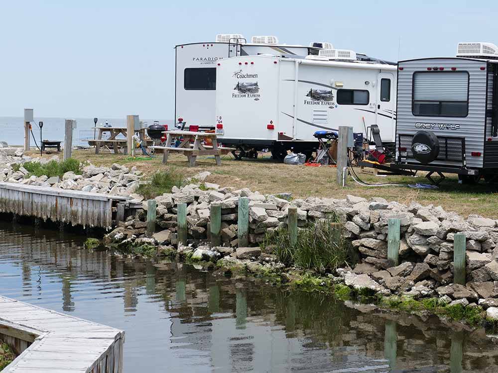 A row of RV sites along the water at FRISCO WOODS CAMPGROUND