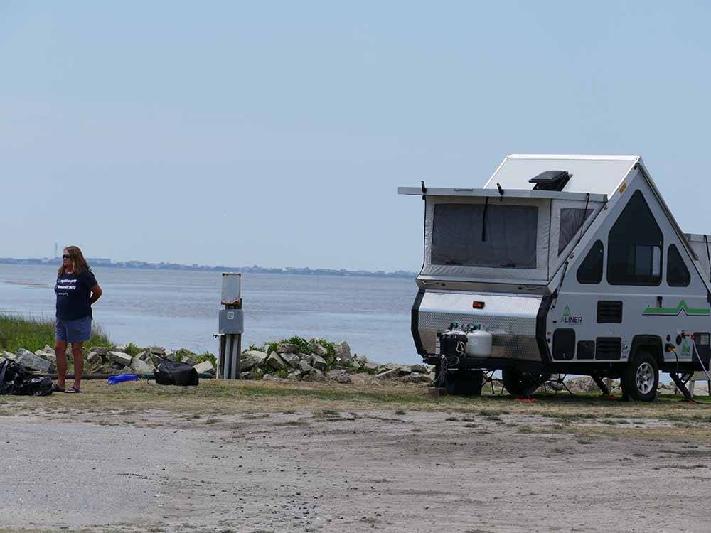 A pop up trailer along the water at FRISCO WOODS CAMPGROUND