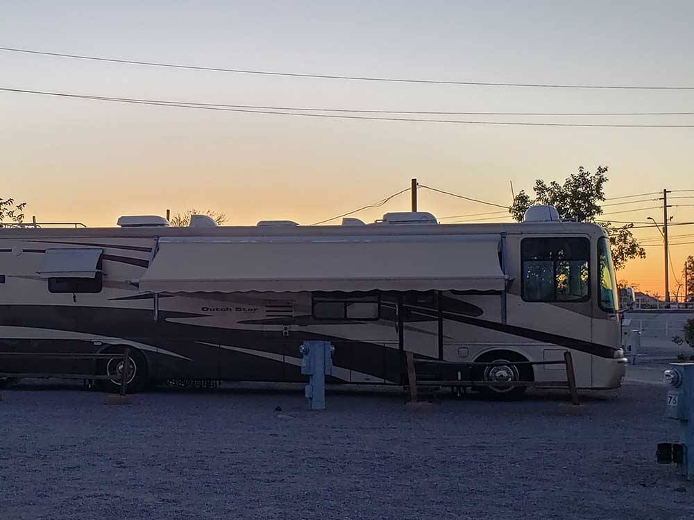Long motorhome at campsite during dusk at 88 SHADES RV PARK