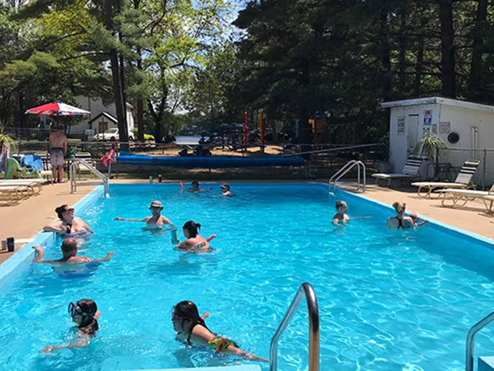 Bathers swim in rectangular pool at BUFFALO LAKE CAMPING RESORT