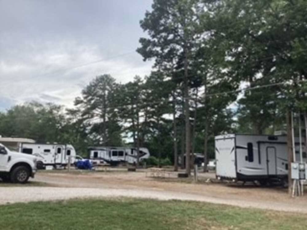 Trailers parked in dirt sites at TREASURE ISLE RV PARK