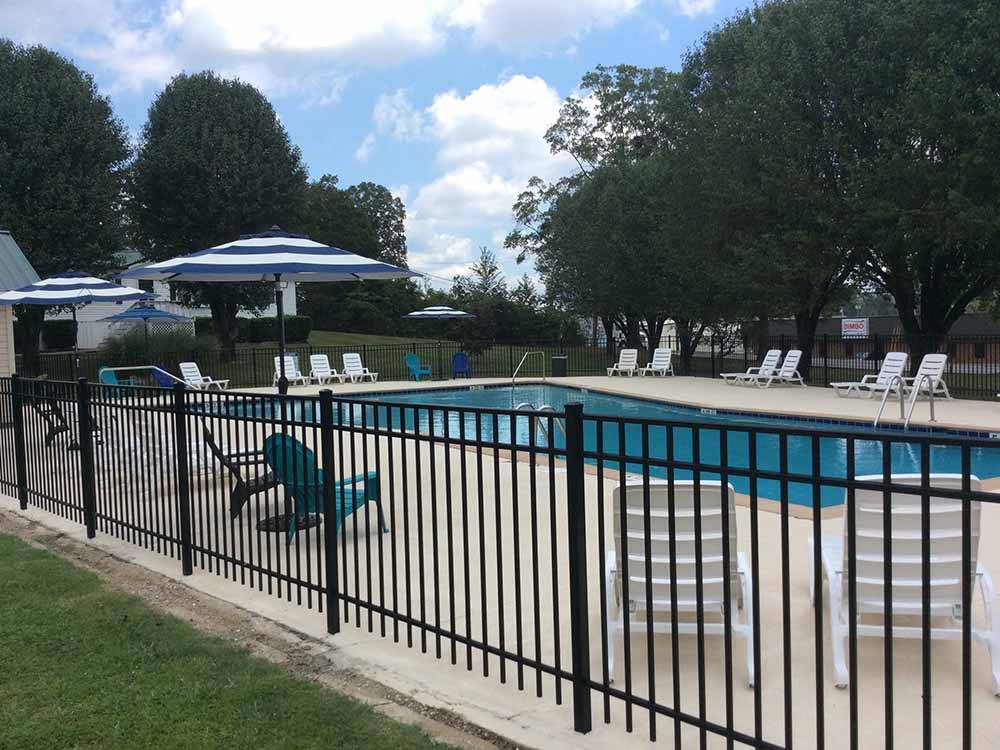 Pool with chairs and shade areas at CHATTANOOGA HOLIDAY TRAVEL PARK